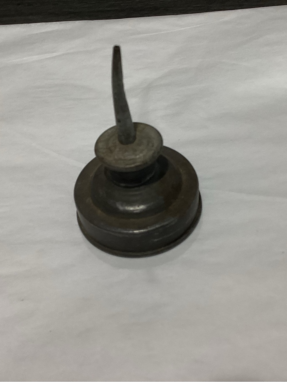 Antique metal Eagle Brand Thumb Pump oil can, likely from the 1930s